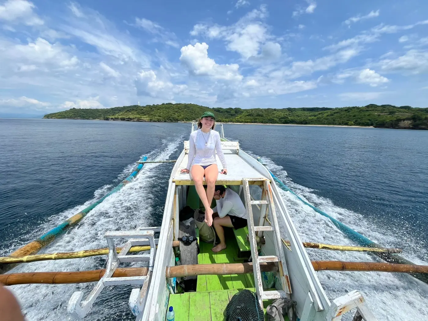 Guest on the boat deck with the island coming into view on a Lombok day trip